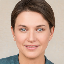 Joyful white young-adult female with short  brown hair and grey eyes