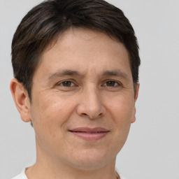 Joyful white adult male with short  brown hair and brown eyes