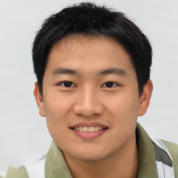 Joyful asian young-adult male with short  brown hair and brown eyes