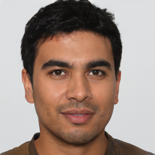 Joyful asian young-adult male with short  brown hair and brown eyes