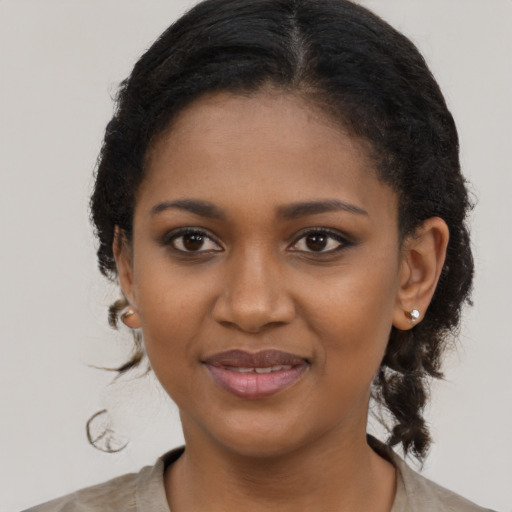 Joyful black young-adult female with medium  black hair and brown eyes