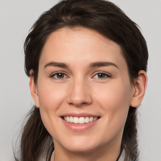 Joyful white young-adult female with medium  brown hair and brown eyes