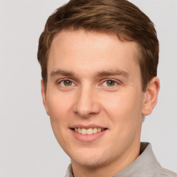 Joyful white young-adult male with short  brown hair and grey eyes