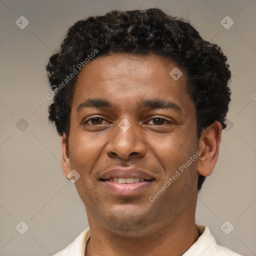 Joyful latino young-adult male with short  brown hair and brown eyes