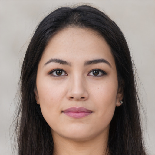 Joyful latino young-adult female with long  brown hair and brown eyes