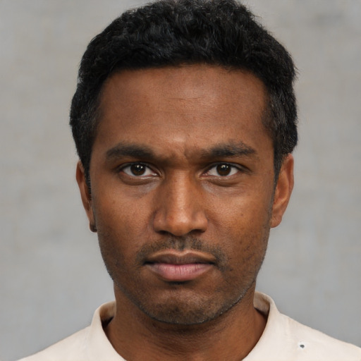Neutral black young-adult male with short  black hair and brown eyes