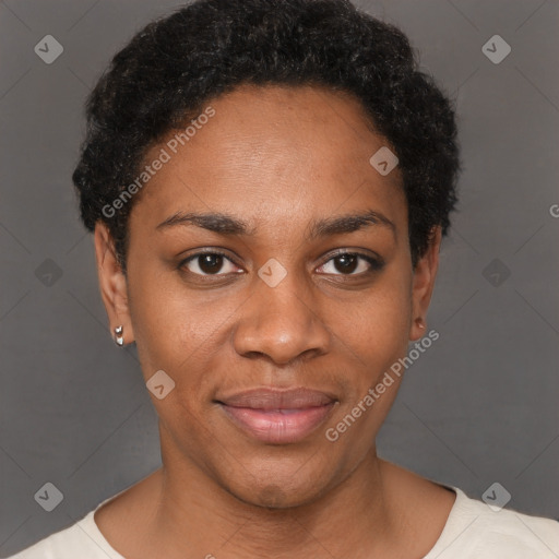 Joyful black young-adult female with short  black hair and brown eyes