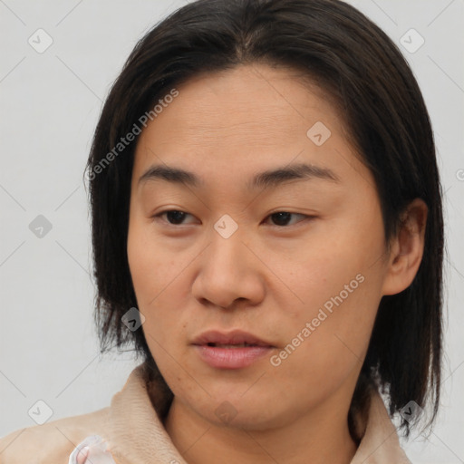 Joyful asian young-adult female with medium  brown hair and brown eyes