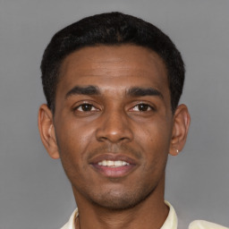 Joyful latino young-adult male with short  brown hair and brown eyes