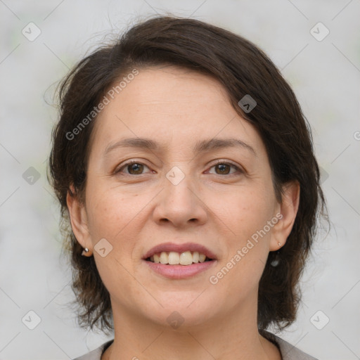 Joyful white adult female with medium  brown hair and brown eyes