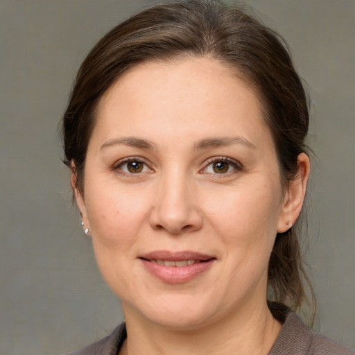 Joyful white adult female with medium  brown hair and brown eyes