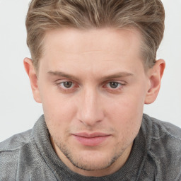 Joyful white young-adult male with short  brown hair and blue eyes