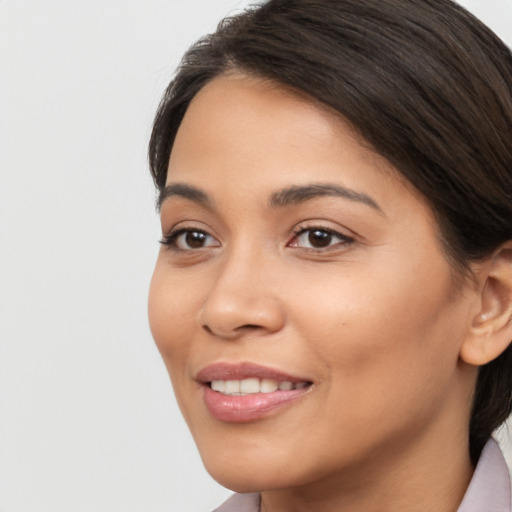 Joyful latino young-adult female with long  brown hair and brown eyes