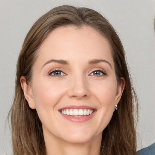 Joyful white young-adult female with long  brown hair and grey eyes