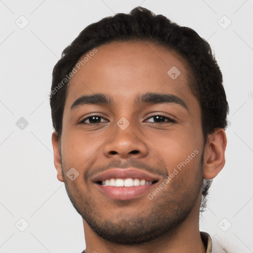 Joyful latino young-adult male with short  brown hair and brown eyes