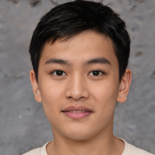 Joyful asian young-adult male with short  black hair and brown eyes