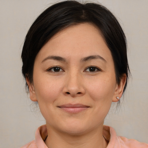 Joyful asian young-adult female with medium  brown hair and brown eyes