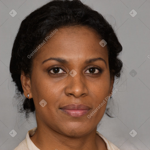 Joyful black adult female with medium  brown hair and brown eyes