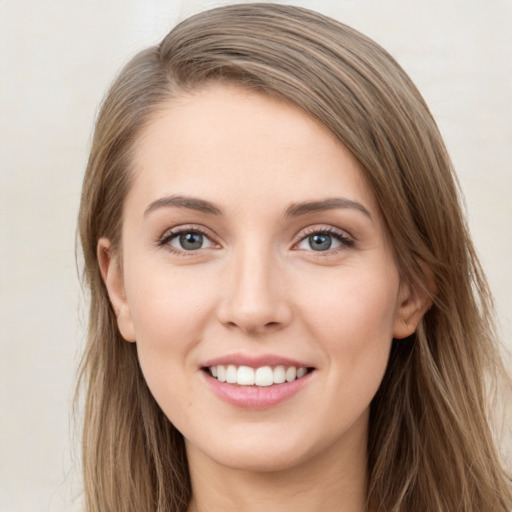 Joyful white young-adult female with long  brown hair and green eyes