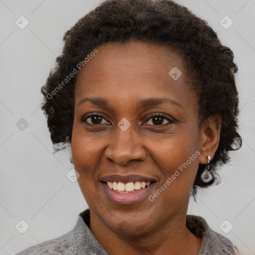 Joyful black adult female with short  brown hair and brown eyes