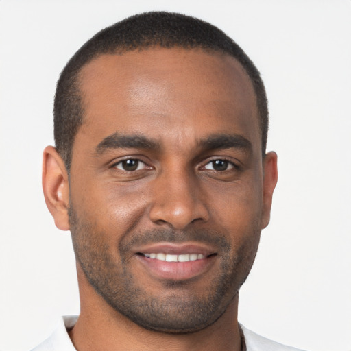 Joyful black young-adult male with short  brown hair and brown eyes