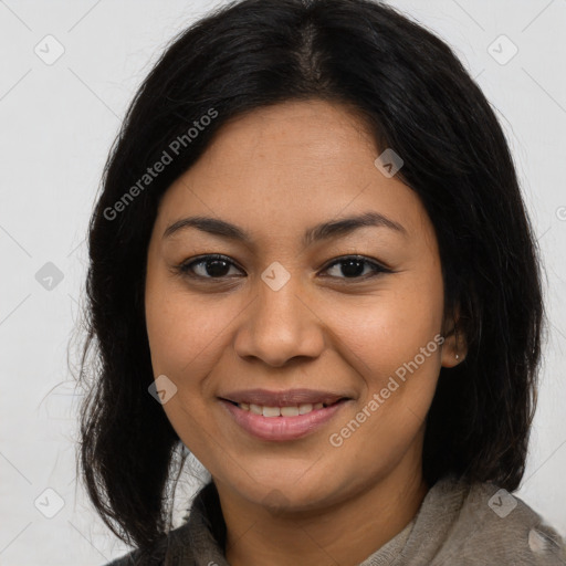 Joyful latino young-adult female with long  brown hair and brown eyes
