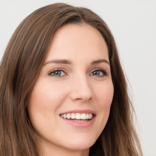 Joyful white young-adult female with long  brown hair and green eyes