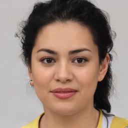 Joyful latino young-adult female with medium  brown hair and brown eyes