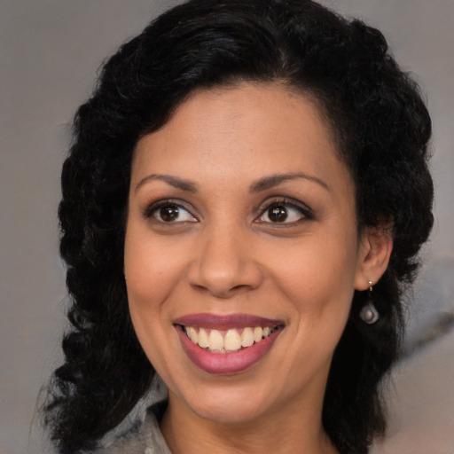 Joyful latino young-adult female with long  black hair and brown eyes