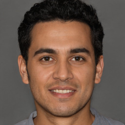 Joyful white young-adult male with short  black hair and brown eyes