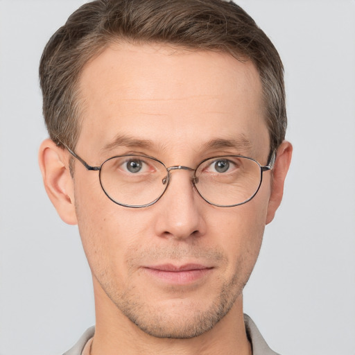 Joyful white adult male with short  brown hair and brown eyes