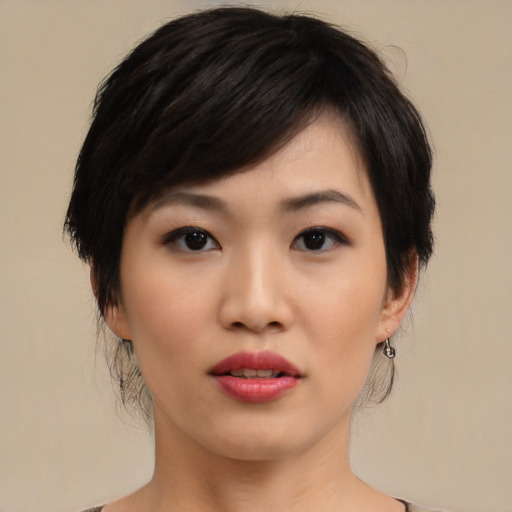 Joyful asian young-adult female with medium  black hair and brown eyes