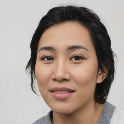 Joyful white young-adult female with medium  black hair and brown eyes