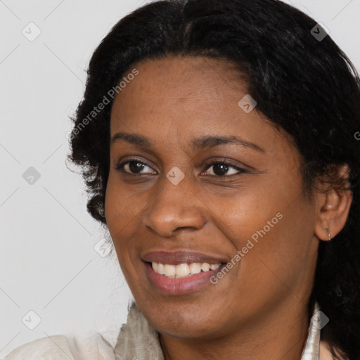 Joyful black adult female with long  black hair and brown eyes