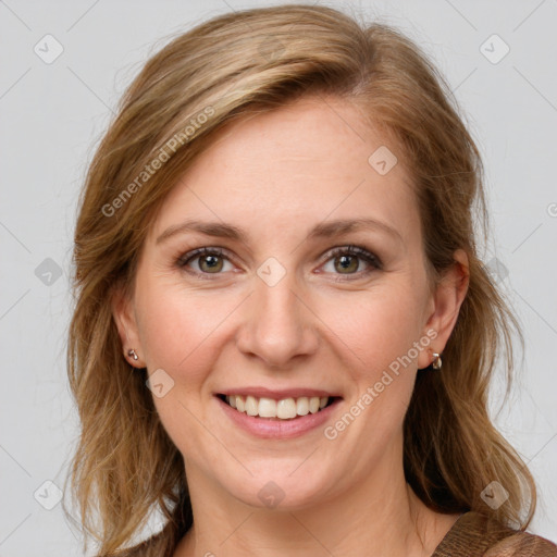 Joyful white young-adult female with medium  brown hair and blue eyes