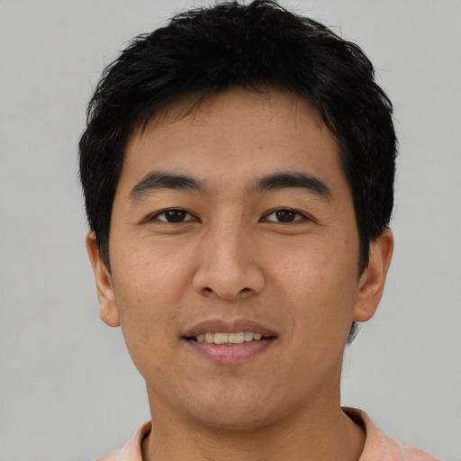 Joyful asian young-adult male with short  black hair and brown eyes