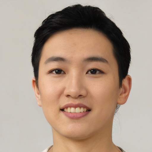 Joyful asian young-adult female with short  black hair and brown eyes