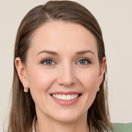 Joyful white young-adult female with long  brown hair and grey eyes