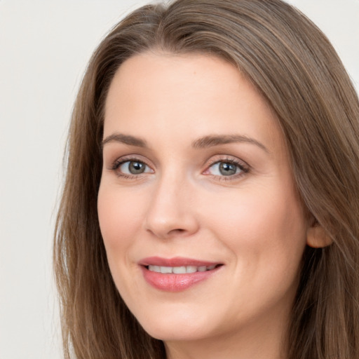 Joyful white young-adult female with long  brown hair and grey eyes