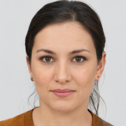 Joyful white young-adult female with medium  brown hair and brown eyes