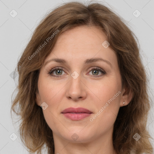 Joyful white adult female with medium  brown hair and green eyes