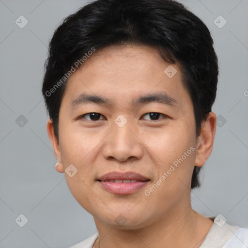 Joyful asian young-adult male with short  black hair and brown eyes