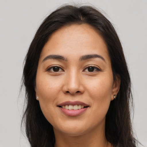 Joyful asian young-adult female with long  brown hair and brown eyes
