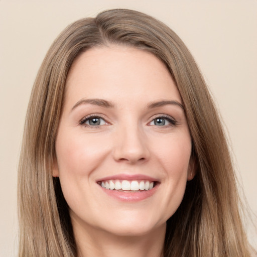 Joyful white young-adult female with long  brown hair and brown eyes