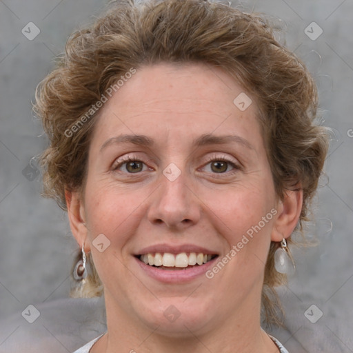 Joyful white adult female with medium  brown hair and blue eyes