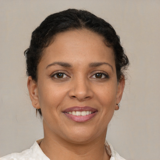 Joyful latino young-adult female with short  brown hair and brown eyes