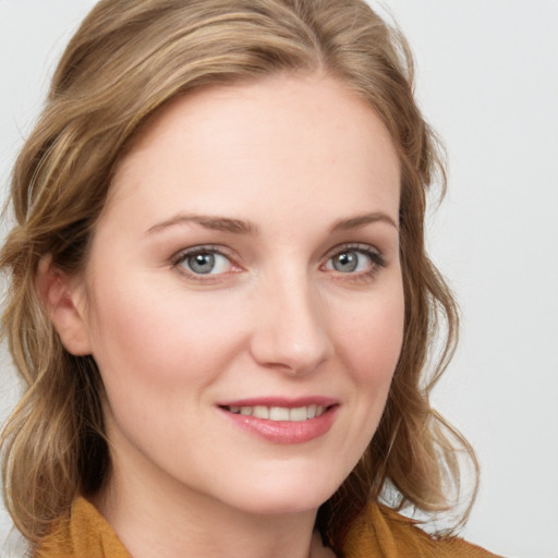 Joyful white young-adult female with medium  brown hair and blue eyes