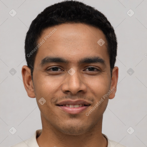 Joyful latino young-adult male with short  black hair and brown eyes