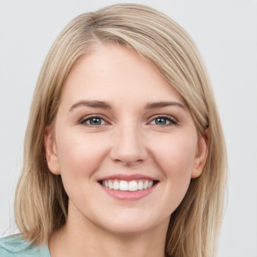 Joyful white young-adult female with long  brown hair and blue eyes