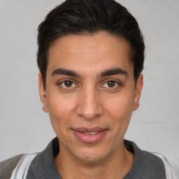 Joyful white adult male with short  brown hair and brown eyes